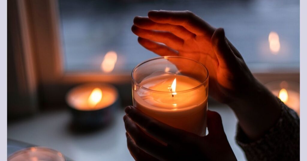 photo of candles in a dark scene to promote relaxation.