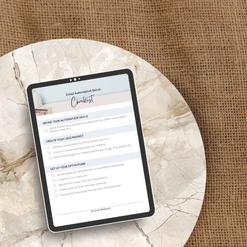 Tablet sitting on a marble table with the email automation checklist displayed on the screen.