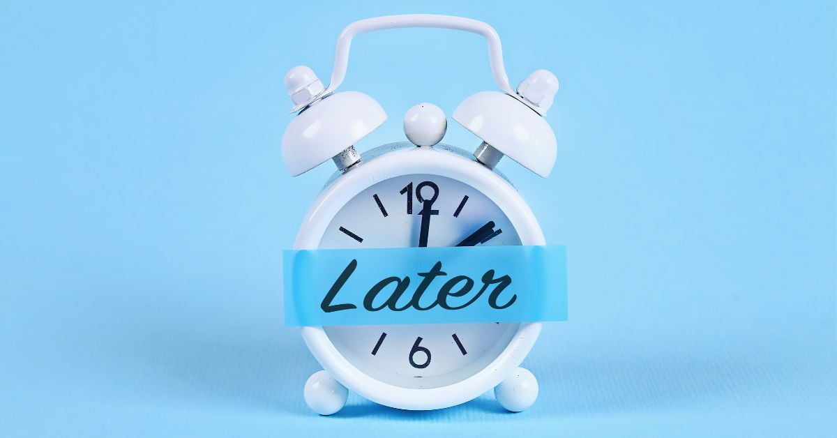 a clock with bells on time with a blue label on the front saying "Later"